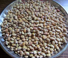 a bowl filled with seeds on top of a wooden table