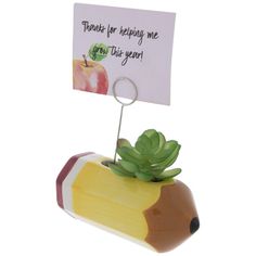 a planter with a note attached to it