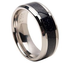 a black and white ring with silver inlays on the inside, is shown