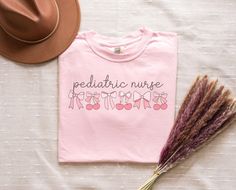 Get ready to love this pediatric nurse shirt! Is the perfect tshirt for any peds team! It will make the best gift for any peds RN who loves bow vibes! * Q U I C K * F A C T S * 100% Ringspun cotton     *CARE INSTRUCTIONS* Machine wash cold; Do not use bleach; tumble dry low; do not dry clean and turn garment inside out * S I Z I N G * Sizing is unisex  Size guide and fit: Below there is a size guide that you can use! For a better fit feel free to compare it with a shirt you currently own! Size / Peds Nursing, Nursing Gifts, Peds Nurse, Pediatric Nurse, Future Nurse, Pediatric Nursing, Notes Design, Nurse Practitioner, Nurse Shirt