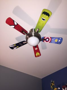 a ceiling fan with different colored blades on it