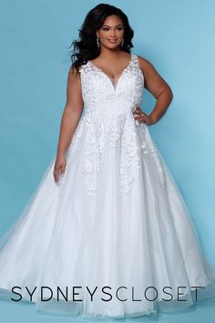 a woman in a white wedding dress posing for a photo with her hands on her hips