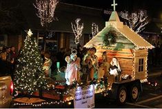 a parade float decorated with christmas lights and decorations