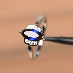 It is a lab sapphire ring. The main stone is 5 mm*10 mm marquise cut.weight about 1.18 carats.The basic metal is sterling silver and plated with rhodium.To change the metal to a solid gold (white/rose) or platinum is also available, please ask for a quotation if you want.You can also go to my shop Home for more elegant rings: https://www.etsy.com/shop/godjewelry?ref=hdr_shop_menu Sapphire is the September birthstone.More sapphire rings:https://www.etsy.com/shop/godjewelry?section_id=20715031Cust Elegant Rings, Ring Blue Sapphire, Gemstone Properties, Blue Sapphire Ring, Ring Blue, September Birthstone, Proposal Ring, Elegant Ring, Blue Sapphire Rings