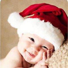 a smiling baby wearing a santa hat