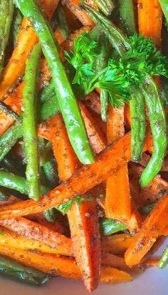 carrots, green beans and parsley on a white plate