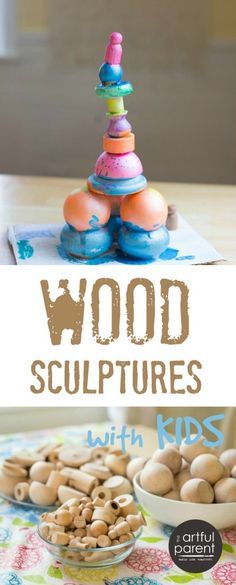 wood sculptures with kids made out of rocks and wooden spoons on a colorful tablecloth