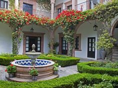 an outdoor courtyard with potted plants and flowers