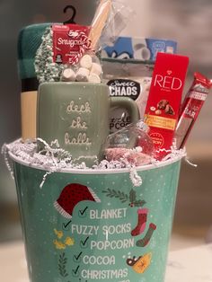 a cup filled with assorted items sitting on top of a table