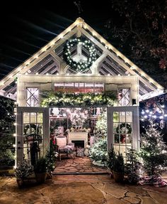 a house decorated for christmas with lights and wreaths