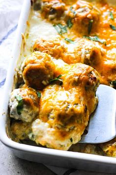 a casserole dish with meatballs and cheese