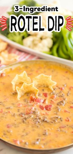 a bowl of soup with tortilla chips on the side and salad in the background