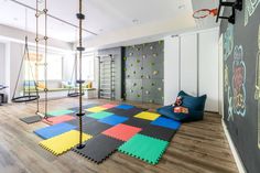 a child's play room with climbing walls and swings