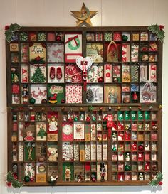 a wooden shelf filled with lots of different types of christmas cards and decorations on top of it