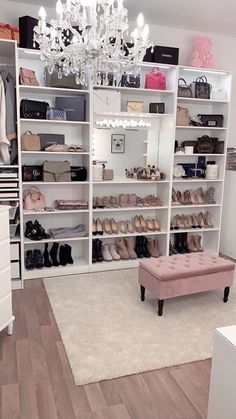 the closet is full of shoes and purses, chandelier in the corner