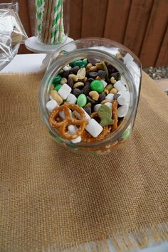 a glass bowl filled with candy and pretzels