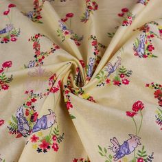 the fabric has flowers and animals on it