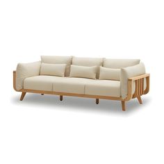 a white couch sitting on top of a wooden frame