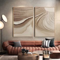 a living room with two paintings on the wall