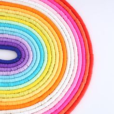 a rainbow colored circle made out of woven material