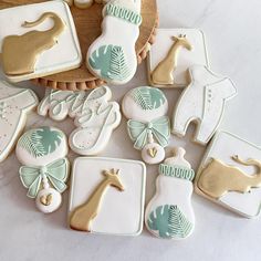 decorated cookies in the shape of animals and giraffes are arranged on a table