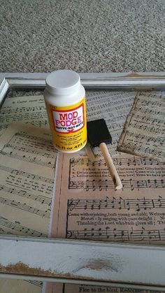 a paintbrush and some sheet music on the floor