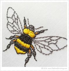 a yellow and black bee on white fabric