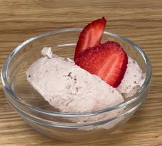 two strawberries are in a bowl on a table