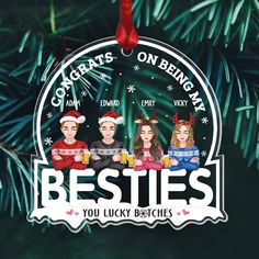 a christmas ornament hanging from a tree with the words besties on it