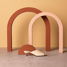 a pair of shoes sitting in front of an arch