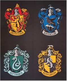 four harry potter house crests hanging on the wall