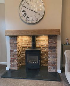 a fireplace with a clock on the wall above it