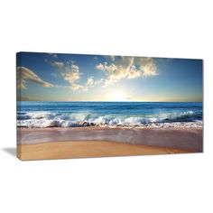 an ocean scene with waves crashing on the beach and clouds in the sky above it