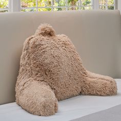 a large teddy bear sitting on top of a couch