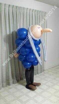 an inflatable balloon man with blue balloons