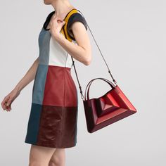 Mix of symmetry and fluid, clean lines, The Sera Tote is designed to complement any modern ensemble. Its exterior design is a surrealist dream, reminiscent of a maze-like structure protruding outwards, with sharp, clean lines, and a 3D façade. Opening the top handles reveals a suede drawstring top edge, securing your belongings on the go. Folding inwards like an accordion and then stretching outwards to store those last-minute belongings. The Sera Tote also features a detachable shoulder strap. Wall Mounted Toilet, Drawstring Top, Secret Sale, Matte Gold, Clean Lines, Cow Leather, Exterior Design, Stretching, Cranberry