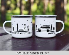 two camper mugs sitting on top of a wooden table