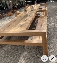 a wooden table sitting on top of a gravel field