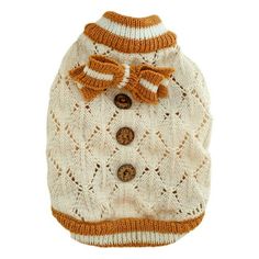 a white sweater with an orange bow on the collar and buttons is knitted to look like