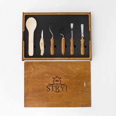 six different types of kitchen utensils in a wooden box with the name story written on it