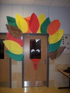 a classroom door decorated to look like a turkey with leaves on it's head