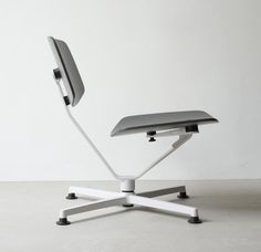 an office chair sitting on top of a white floor