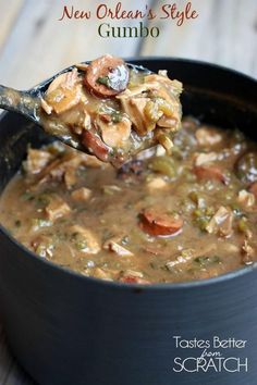 a spoon full of soup on top of a wooden table