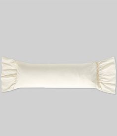 a white pillow with ruffled edges on a gray background