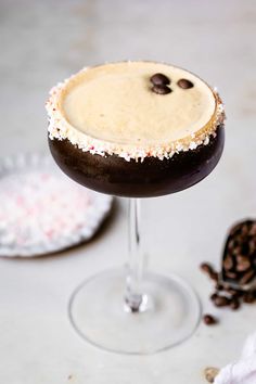 a chocolate martini with sprinkles on the rim and an oreo cookie