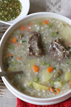 a bowl of soup with meat and vegetables