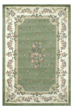 a green rug with flowers on it