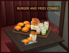 burgers and fries combo sitting on a tray with condiments in front of them