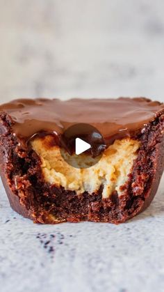 a close up of a chocolate cupcake on a table