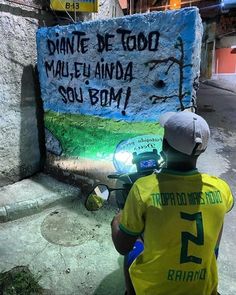 a man sitting in front of a sign